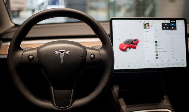 The inside of a Tesla car Model 3 is seen at a Tesla shop inside of a shopping Mall in Beijing on May 26, 2021. (Photo by NICOLAS ASFOURI / AFP)