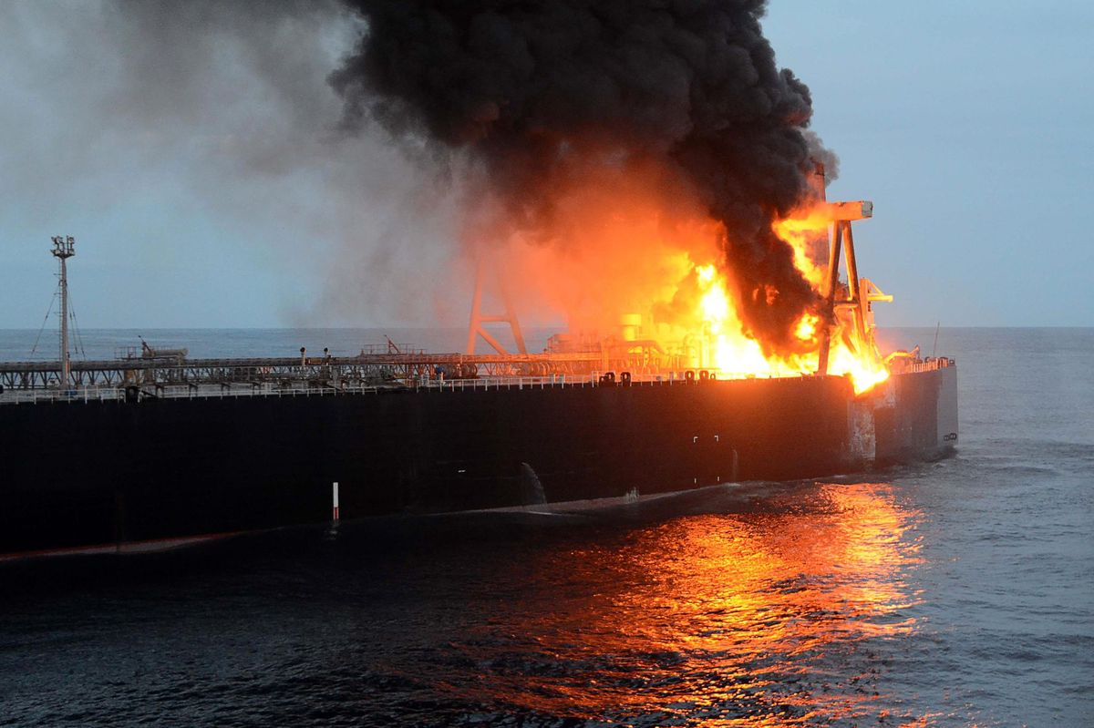 This handout photograph taken on September 4, 2020, and released by Sri Lanka's Air Force, shows black smoke coming out from the Panamanian-registered crude oil tanker New Diamond, some 60 km off Sri Lanka's eastern coast. - Indian warships on September 3 aided Sri Lanka's navy to extinguish a fire on a massive oil tanker off the island's eastern coast, officials said. (Photo by - / Sri Lankan Air Force / AFP) / RESTRICTED TO EDITORIAL USE - MANDATORY CREDIT "AFP PHOTO /Sri Lankan Air Force " - NO MARKETING - NO ADVERTISING CAMPAIGNS - DISTRIBUTED AS A SERVICE TO CLIENTS