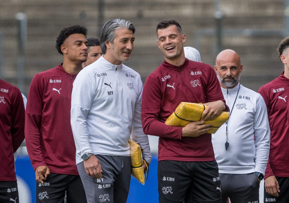 Switzerland's head coach Murat Yakin (3rd L) and Switzerland's midfielder #10 Granit Xhaka (4th L) react during an official welcome ceremony prior to their first training at their base camp ahead of the UEFA EURO 2024 football tournament in Stuttgart on June 10, 2024. (Photo by Fabrice COFFRINI / AFP)