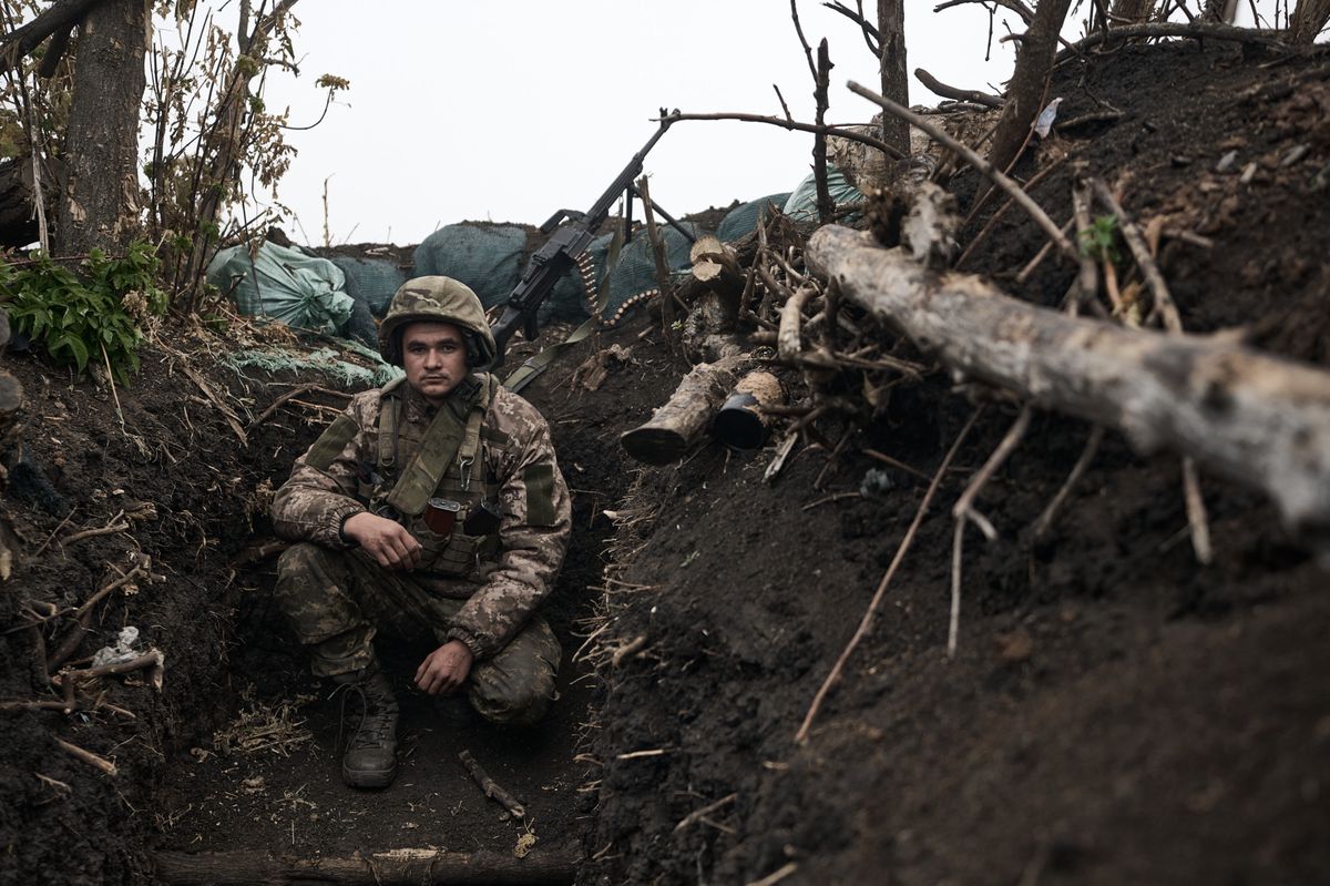 BAKHMUT DISTRICT, UKRAINE - OCTOBER 25: (EDITOR'S NOTE: No use after 24 November, 2023. For any subsequent use after this date, image must be re-licensed.) Portrait of a soldier in his observation position near the PKM machine gun in the morning fog, as the 10th Mountain Assault Brigade 'Edelveys' operate at the zero frontline with infantry holding fire at positions 100 meters below Russian positions, on October 25, 2023 in the Bakhmut district of Ukraine. Ukrainian forces continue to fight to retake Bakhmut, which was captured by Russian forces in May, following a yearlong battle. Over the summer, Ukraine regained territory north and south of Bakhmut but Russia has held the city itself. (Photo by Kostya Liberov/Libkos via Getty Images)