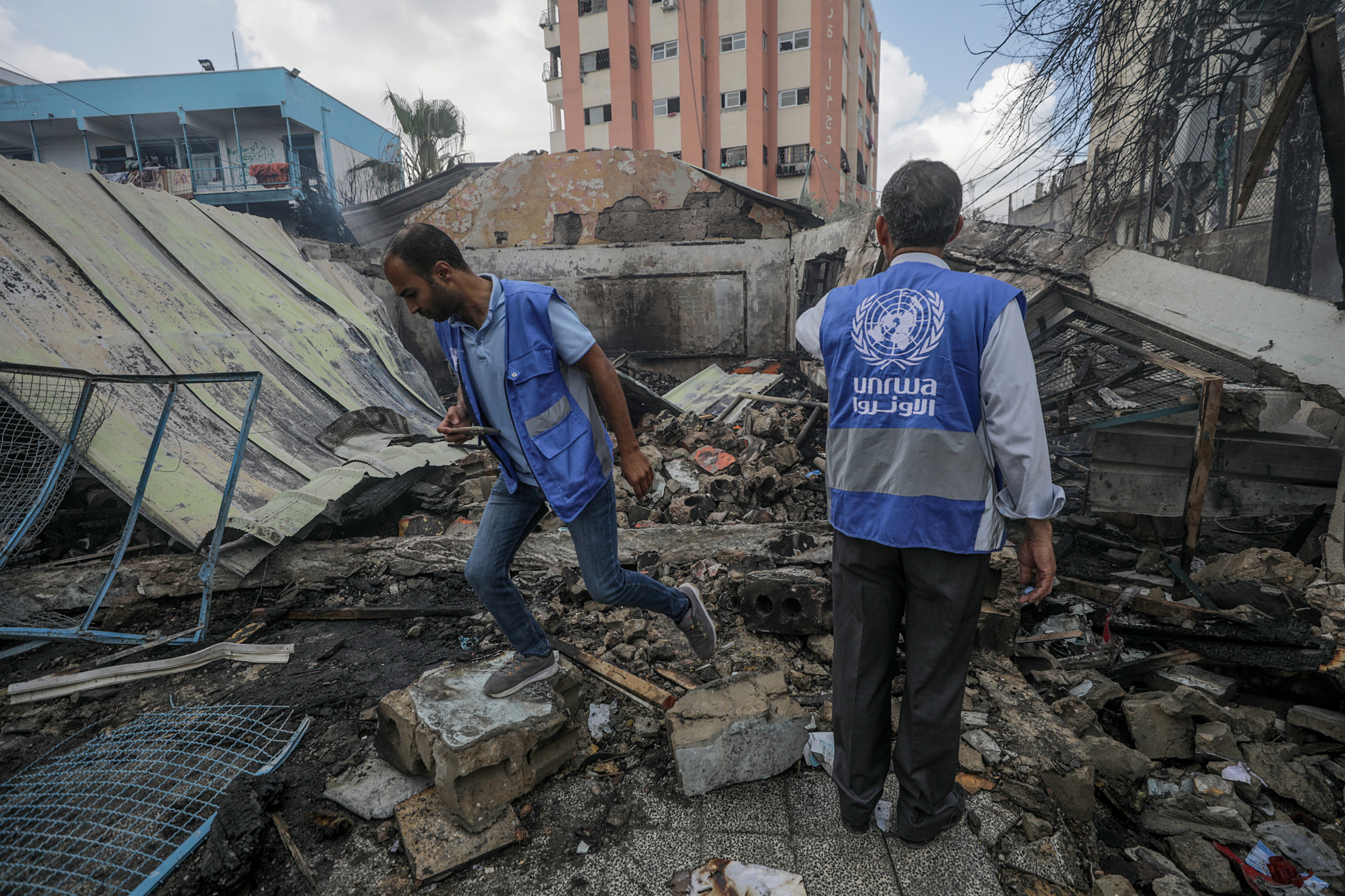 epa11339644 UNRWA employees inspect a destroyed United Nations school following an air strike in Al Nuseirat refugee camp, central Gaza Strip, 14 May 2024.  At least six people were killed in the strike which hit the UNRWA (United Nationas Relief and Works Agency for Palestinians in the near east) school, according to the Palestinian Civil Defense in Gaza. More than 35,000 Palestinians and over 1,455 Israelis have been killed, according to the Palestinian Health Ministry and the Israel Defense Forces (IDF), since Hamas militants launched an attack against Israel from the Gaza Strip on 07 October 2023, and the Israeli operations in Gaza and the West Bank which followed it.  EPA/MOHAMMED SABER