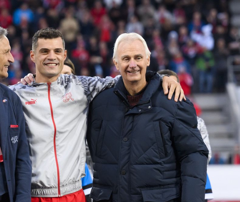 Switzerland's midfielder Granit Xhaka, center, is honored for his 118th selection for the Swiss national team with Switzerland's soccer federation president Dominique Blanc, left, and Werner Mogg, his U16 coach at FC Basel, right, during the UEFA Euro 2024 qualifying group I soccer match between Switzerland and Belarus, at the Kybunpark stadium in St. Gallen, Switzerland, Sunday, October 15, 2023. (KEYSTONE/Gian Ehrenzeller)