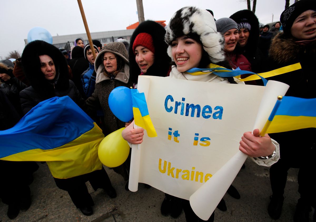Crimean Tatars shout slogans during the pro-Ukraine rally in Simferopol, Crimea, Ukraine, Monday, March 10, 2014.  Russian President Vladimir Putin on Sunday defended the separatist drive in the disputed Crimean Peninsula as in keeping with international law, but Ukraine's prime minister vowed not to relinquish "a single centimeter" of his country's territory. The local parliament in Crimea has scheduled a referendum for next Sunday. (AP Photo/Darko Vojinovic)