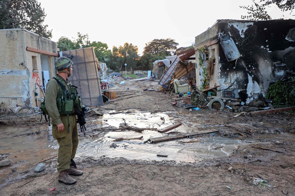 CORRECTION / TOPSHOT - Israeli troops search the scene of a Palestinian militant attack in the Israeli kibbutz of Kfar Aza on the border with the Gaza Strip on October 11, 2023. Thousands have died and the toll continues to climb dramatically five days after Palestinian militants launched a surprise attack on Israel, which has responded with a massive bombardment of Gaza. (Photo by GIL COHEN-MAGEN / AFP) / “The erroneous mention[s] appearing in the metadata of this photo by GIL COHEN-MAGEN
 has been modified in AFP systems in the following manner: [Palestinian militant attack] instead of [rocket attack]. Please immediately remove the erroneous mention[s] from all your online services and delete it (them) from your servers. If you have been authorized by AFP to distribute it (them) to third parties, please ensure that the same actions are carried out by them. Failure to promptly comply with these instructions will entail liability on your part for any continued or post notification usage. Therefore we thank you very much for all your attention and prompt action. We are sorry for the inconvenience this notification may cause and remain at your disposal for any further information you may require.”