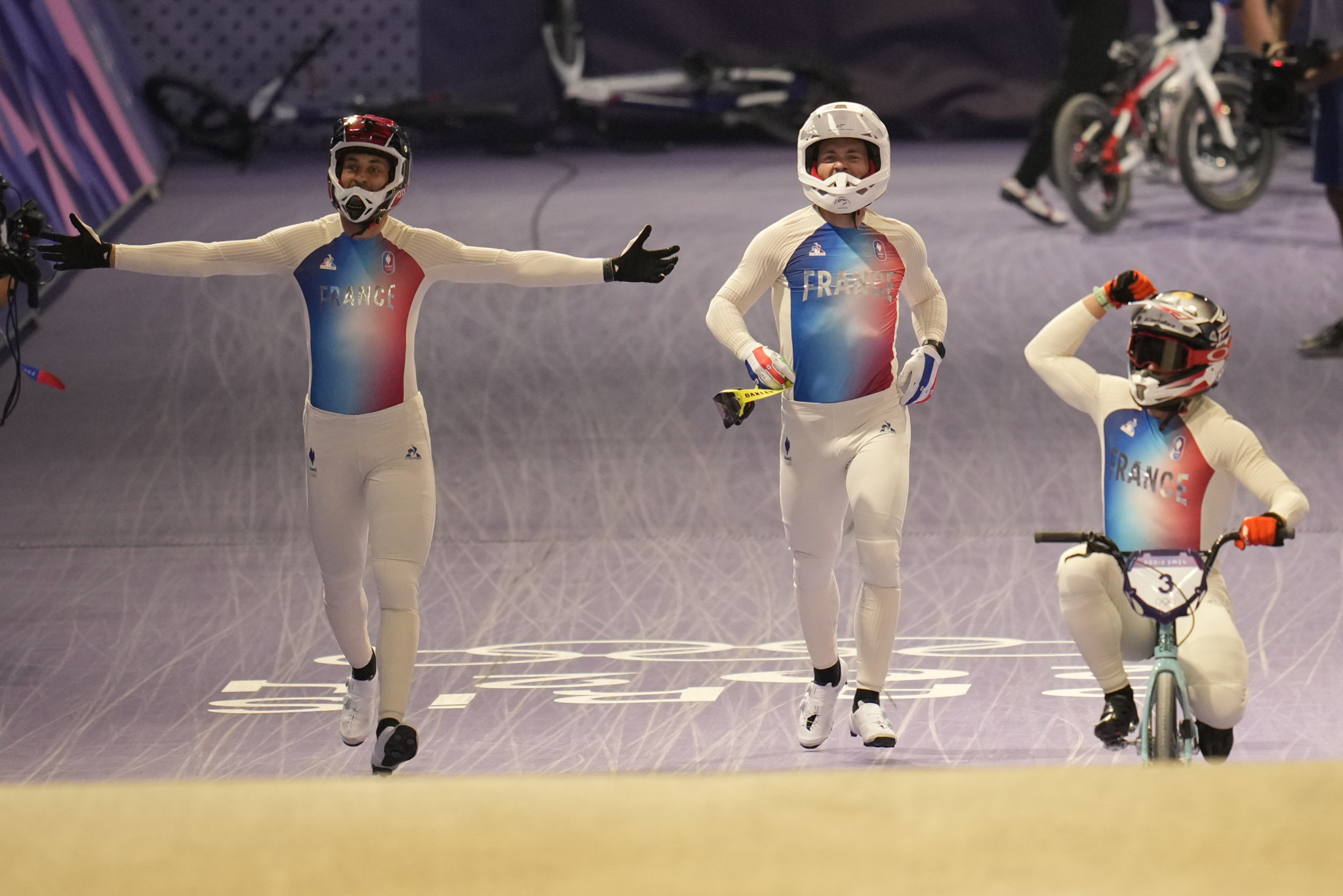 From left, gold medallist Joris Daudet of France, bronze medallist Romain Mahieu of France and silver medallist Sylvain Andre of France celebrate after a BMX racing event, at the 2024 Summer Olympics, Friday, Aug. 2, 2024, in Saint-Quentin-en-Yvelines, France. (AP Photo/Ricardo Mazalan)