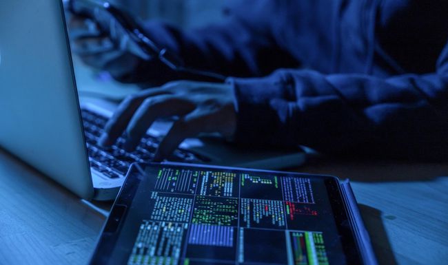 Payments System Hacking. Online Credit Cards Payment Security Concept. Hacker in Black Gloves Hacking the System.