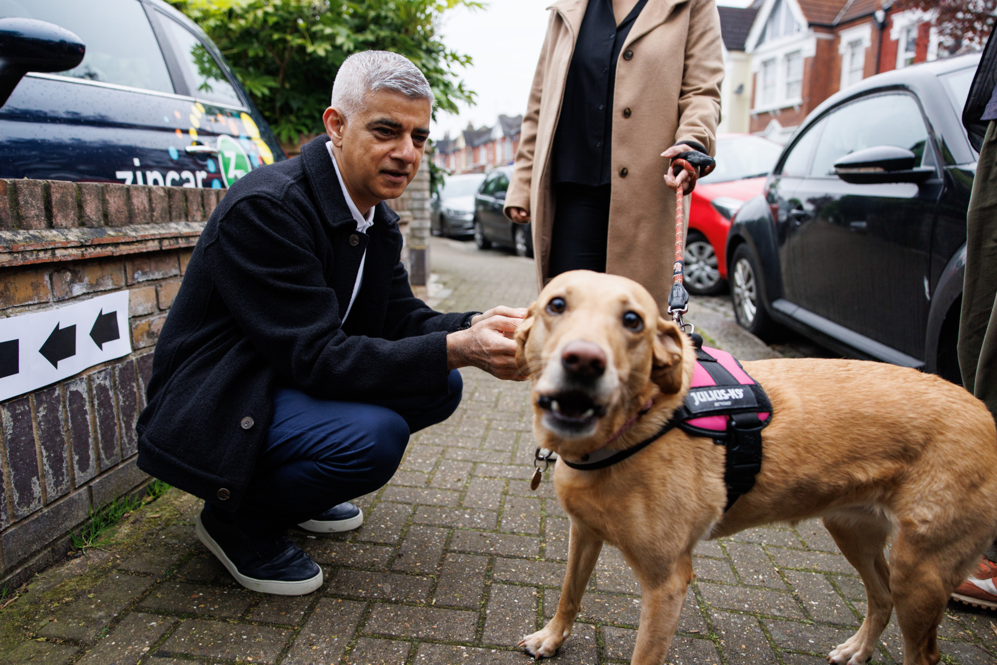 epa11313871 Mayor of London Sadiq Khan poses with his dog Luna, outside of a polling station after voting in local elections in London, Britain, 02 May 2024. Local, regional, and police commissioner elections take place across England and Wales on 02 May 2024.  EPA/TOLGA AKMEN