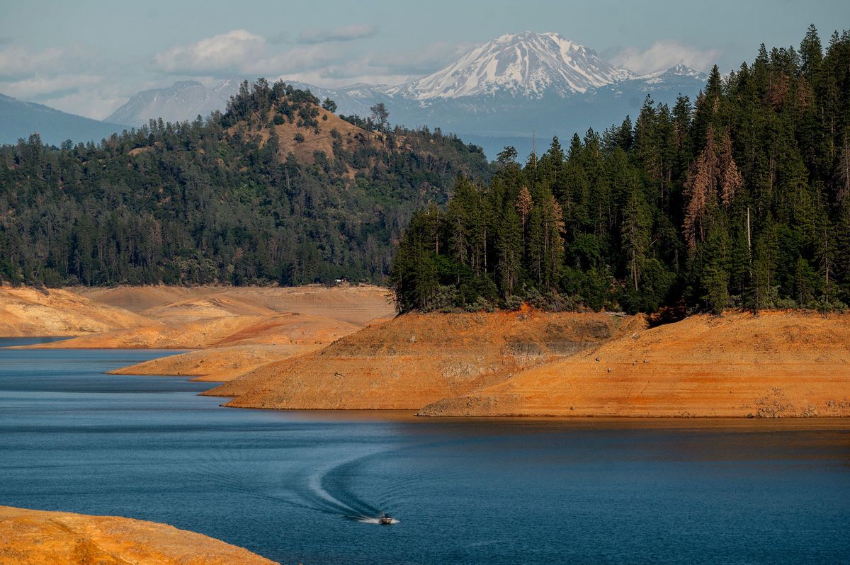 A boat crosses Shasta Lake on Sunday, May 23, 2021, in Shasta Trinity National Forest, Calif. The reservoir is at 45 percent of capacity and 52 percent of its historical average. (AP Photo/Noah Berger)