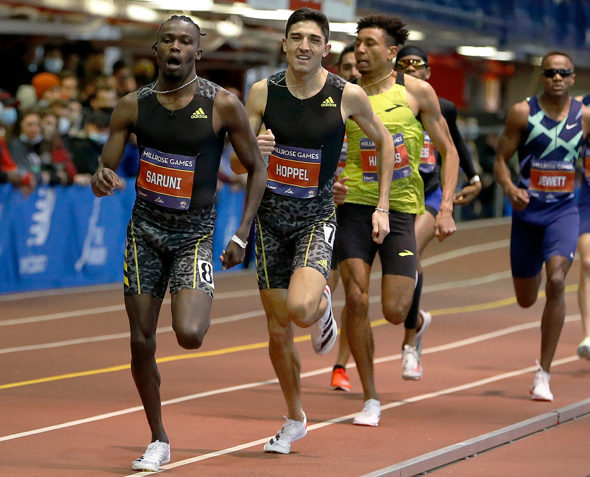 Kenya's Michael Saruni (L) and Bryce Hoppel (C) of the United States vie for the lead in the Mike Frankfurt Men's 800 Meter race during the 114th Millrose Games held at The Armory Track on January 29, 2022 in New York City. Former African indoor 800m record holder Michael Saruni has been banned for four years for allegedly sending someone to impersonate him during a drugs test, the Anti-Doping Association of Kenya (ADAK) announced on February 6, 2024. (Photo by MICHAEL COHEN / GETTY IMAGES NORTH AMERICA / AFP)