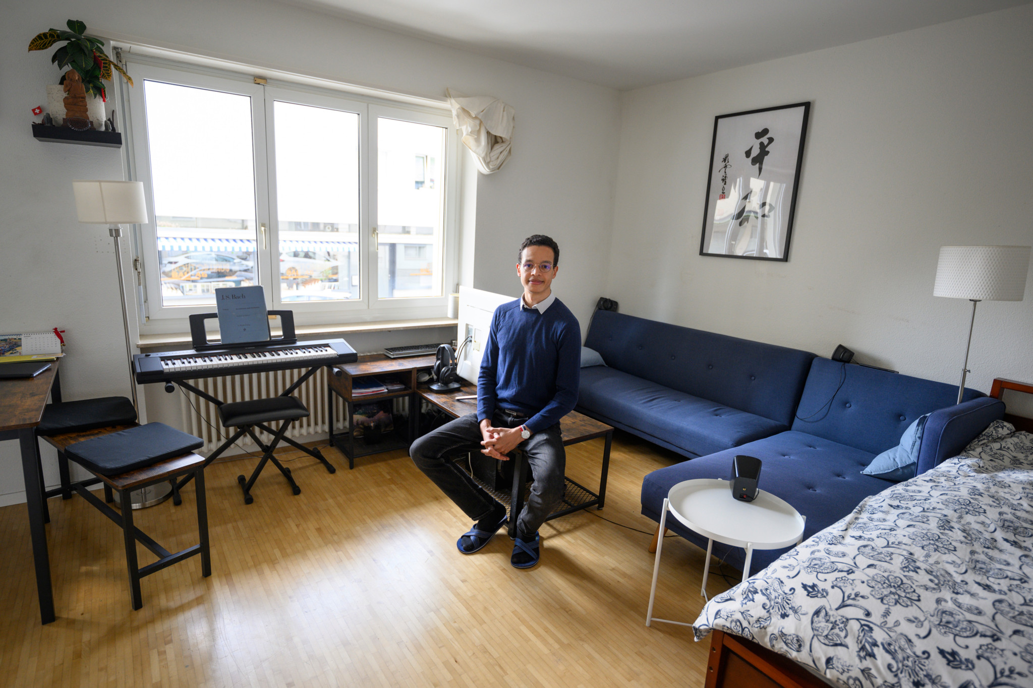 Nicolas Parzy-Jagla sits in his cozy living room in Basel. He is a follower of the FIRE movement and aims to be financially independent in a year.