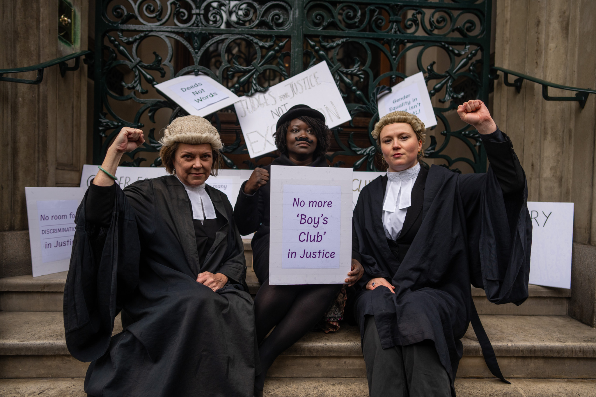 LONDON, ENGLAND - MARCH 28: Female lawyers hold placards on the steps of the Garrick Club on March 28, 2024 in London, England. The group of high-profile female lawyers delivered an open letter to the club today demanding it end its policy of restricting membership to men only. Following recent media coverage of the elite all-male private members' club, several members announced their resignation from the club, including senior government officials.(Photo by Carl Court/Getty Images)