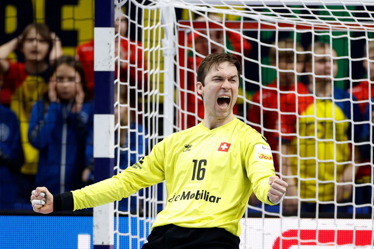Switzerland's goalkeeper #16 Nikola Portner celebrates after saving a penalty shot during the men's EURO 2024 EHF Handball European Championship match Group A Switzerland v France in Berlin on January 14, 2024. (Photo by Odd ANDERSEN / AFP)