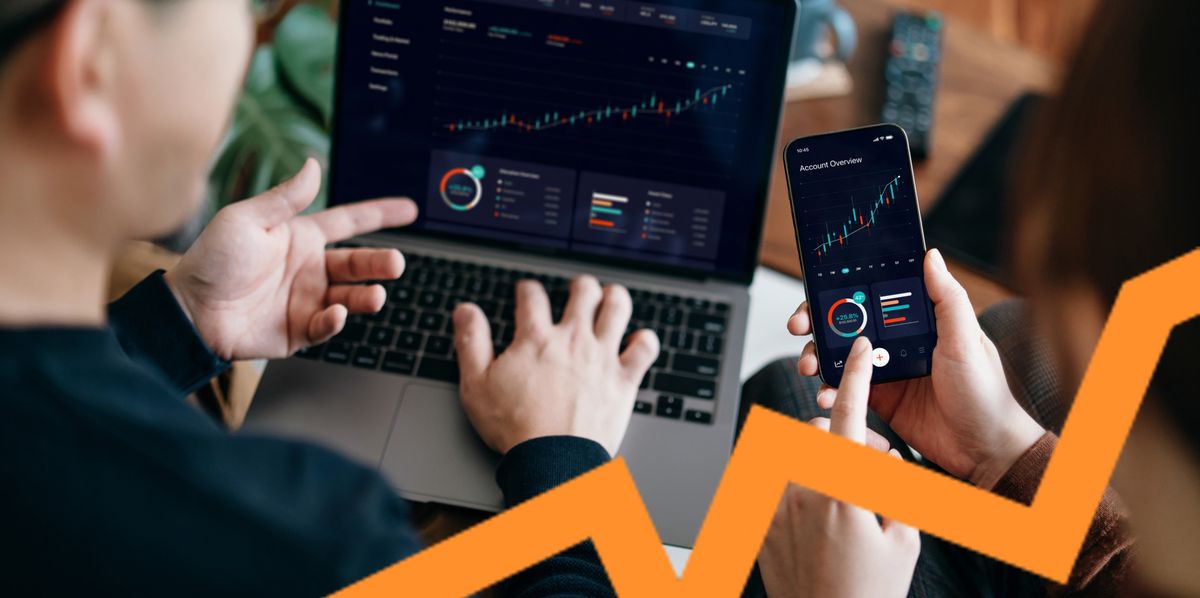 Young Asian couple managing finance and investment online, analyzing stock market trades with mobile app on laptop and smartphone. Making financial plans. Banking and finance, investment, financial trading, mobile banking concept