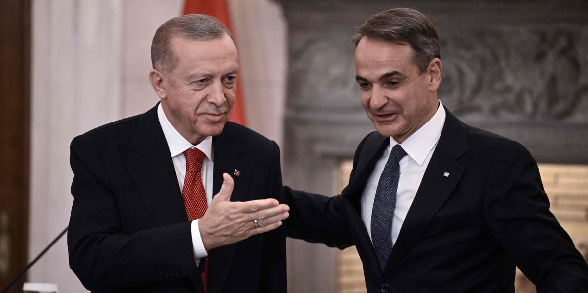 Turkish President Recep Tayyip Erdogan (L) and Greek Prime Minister Kyriakos Mitsotakis leave after speaking to the press following their meeting during Erdogan's official visit to Greece, in Athens, on December 7, 2023. The Turkish president is in Athens on December 7 in a keenly watched visit billed as an attempted "new chapter" between the NATO allies and historic rivals after years of tension. (Photo by Angelos Tzortzinis / AFP)