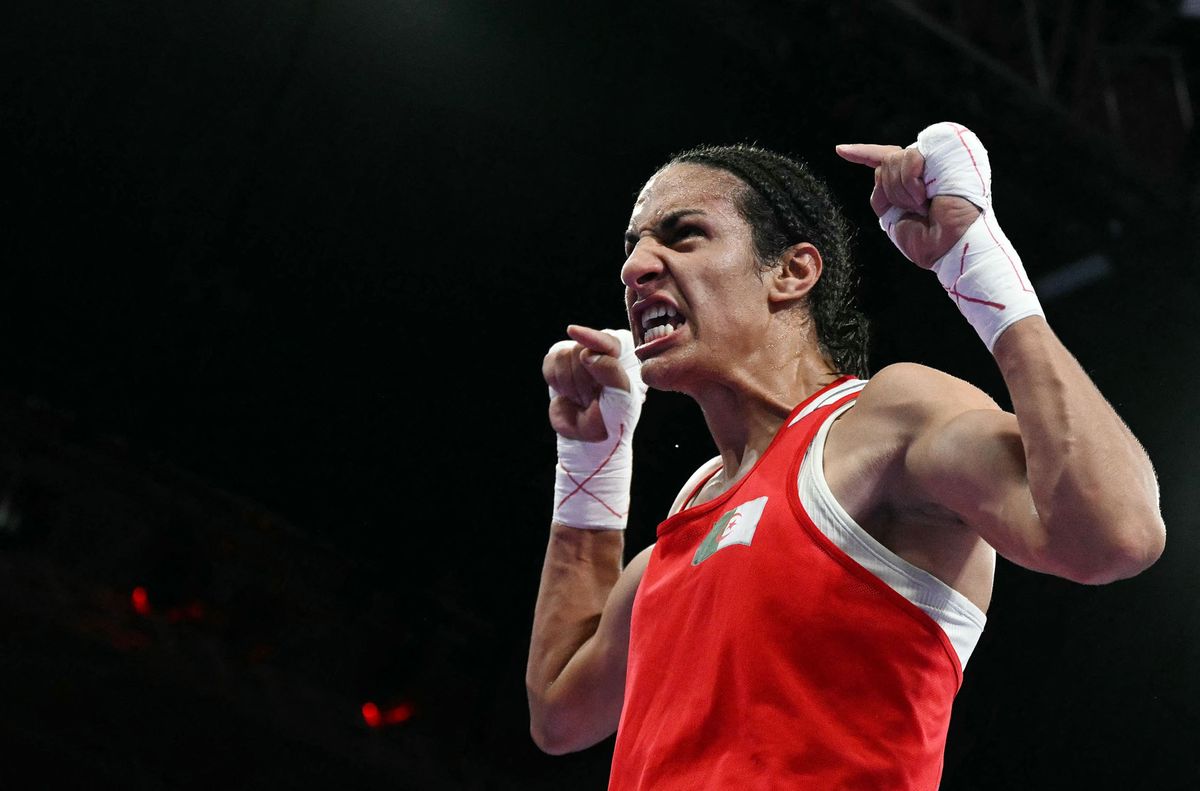 TOPSHOT - Algeria's Imane Khelif celebrates her victory over Hungary's Anna Luca Hamori in the women's 66kg quarter-final boxing match during the Paris 2024 Olympic Games at the North Paris Arena, in Villepinte on August 3, 2024. (Photo by MOHD RASFAN / AFP)