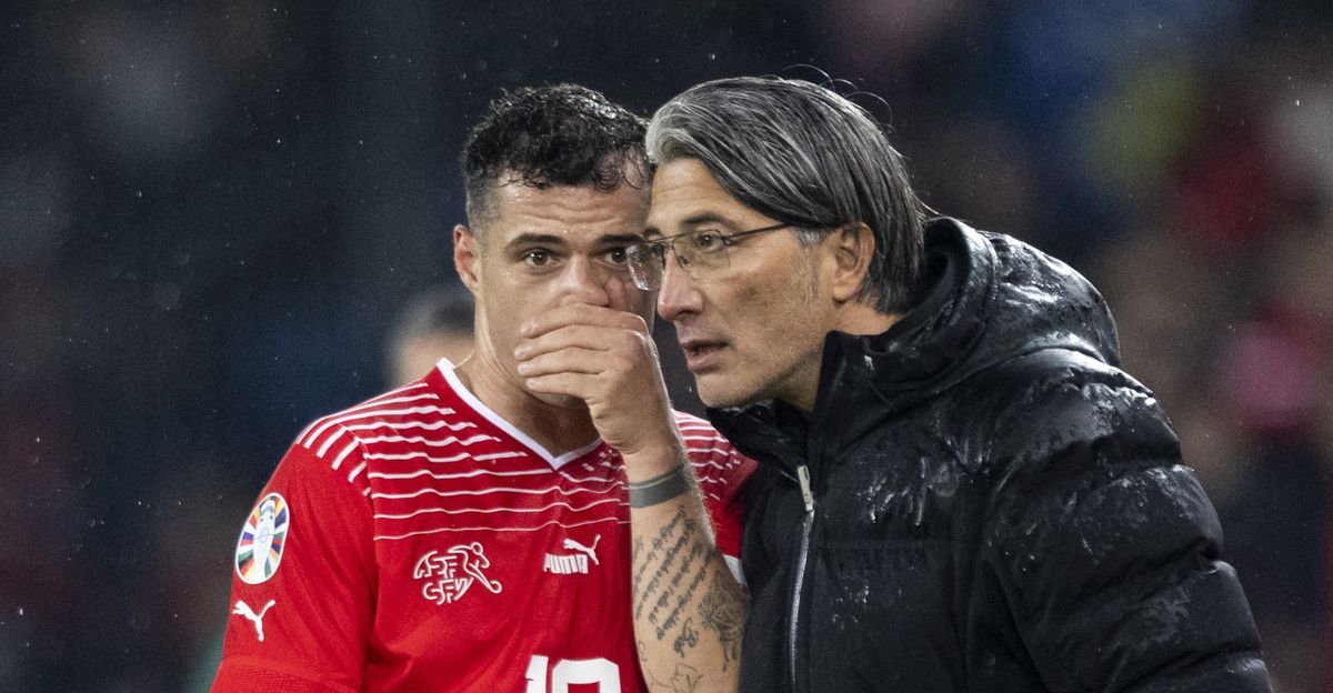 Switzerland's head coach Murat Yakin speaks with Granit Xhaka during the UEFA Euro 2024 qualifying group I soccer match between Switzerlandat and Kosovo at the St. Jakob-Park stadium in Basel, Switzerland, on Saturday, November 18, 2023. (KEYSTONE/Ennio Leanza)