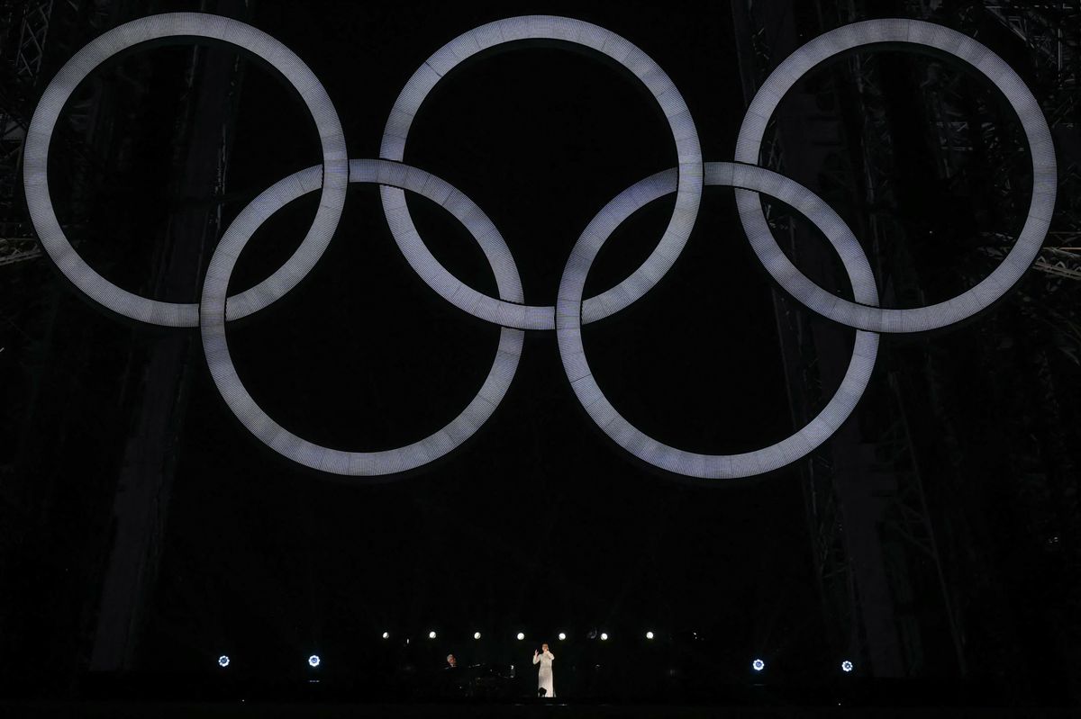 Canadian singer Celine Dion performs on the first floor of the Eiffel Tower which features the Olympic Rings during the opening ceremony of the Paris 2024 Olympic Games in Paris on July 26, 2024. (Photo by MARTIN BERNETTI / AFP)