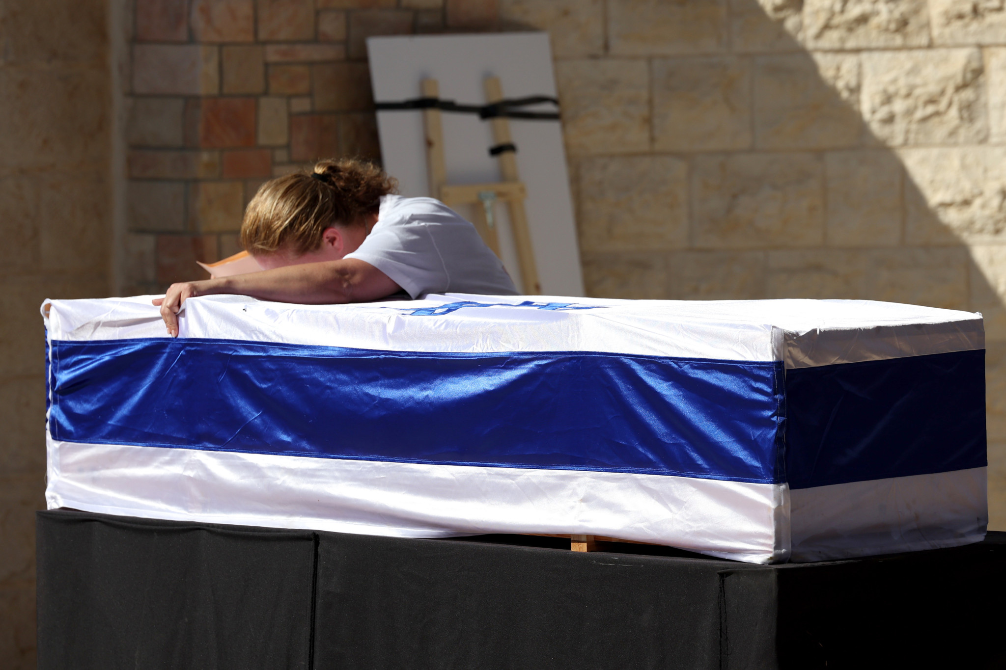 Adi Marciano mourns on the coffin of her daughter, Israeli soldier Noa Marciano, during her funeral in Modiin, Israel, 17 November 2023. Noa Marciano's body was found and extracted on 16 November by Israeli troops from a building adjacent to the Shifa Hospital in Gaza. More than 11,000 Palestinians and at least 1,200 Israelis have been killed, according to the Israel Defense Forces (IDF) and the Palestinian health authority, since Hamas militants launched an attack against Israel from the Gaza Strip on 07 October, and the Israeli operations in Gaza and the West Bank which followed it.  EPA/ABIR SULTAN