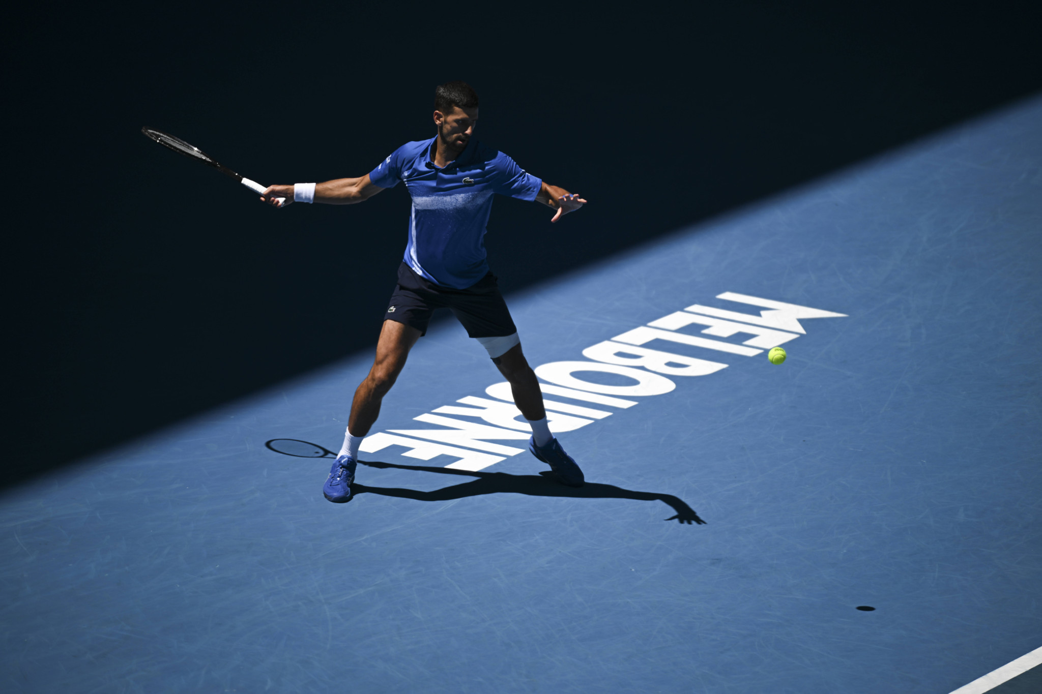 Novak Djokovic returns during a semi-final match at the 2025 Australian Open in Melbourne.