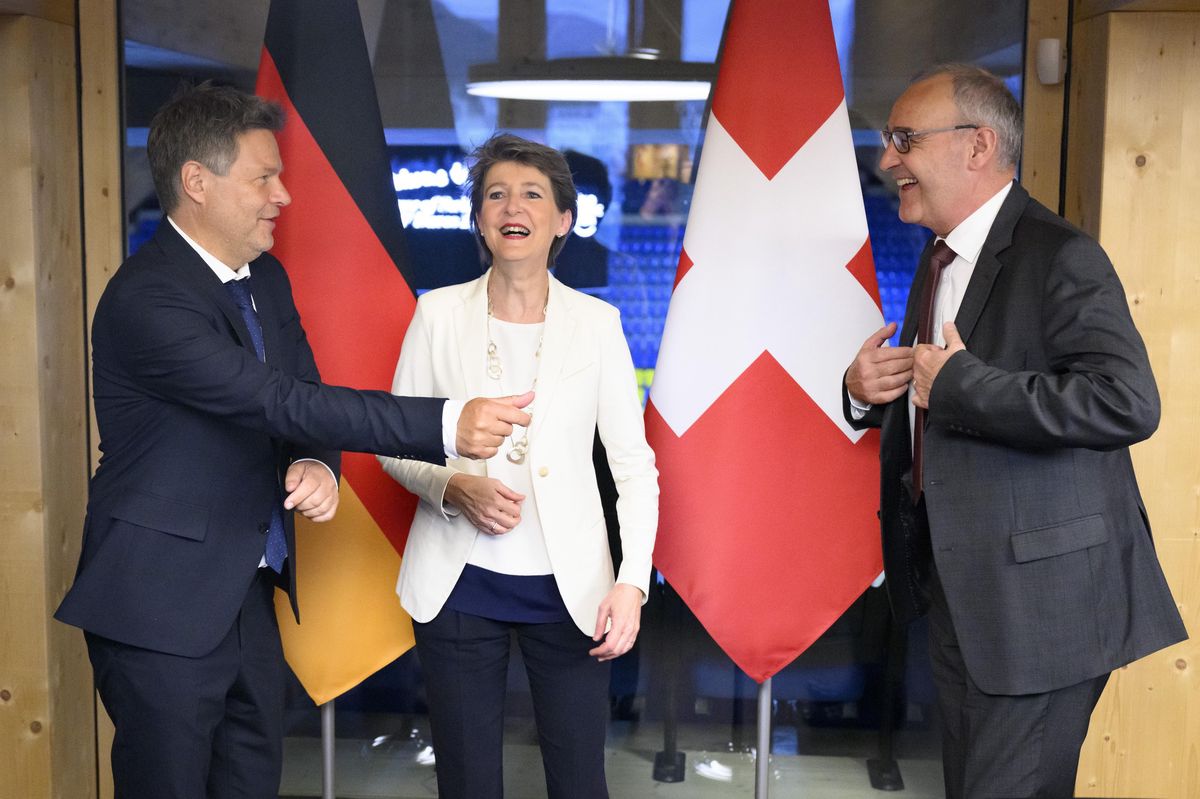 Switzerland's Simonetta Sommaruga, center, Federal councillor for the environment, transport, energy and communications and Switzerland's Guy Parmelin, right, Federal councillor for economic affairs, Education and research speak with Germany's Robert Habeck, left, vice-chancellor and Federal minister for economy and climate action during a bilateral meeting at the House of Switzerland on the sideline of the 51st annual meeting of the World Economic Forum, WEF, in Davos, Switzerland, on Sunday, May 22, 2022. The forum has been postponed due to the Covid-19 outbreak and was rescheduled to early summer. The meeting brings together entrepreneurs, scientists, corporate and political leaders in Davos under the topic "History at a Turning Point: Government Policies and Business Strategies" from 22 - 26 May 2022. (KEYSTONE/Laurent Gillieron)