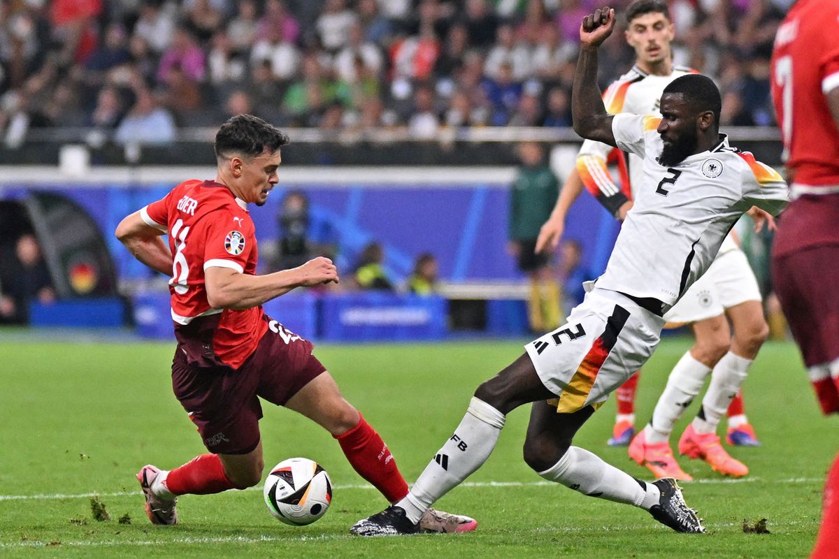 Switzerland's midfielder #26 Fabian Rieder and Germany's defender #02 Antonio Ruediger fight for the ball during the UEFA Euro 2024 Group A football match between Switzerland and Germany at the Frankfurt Arena in Frankfurt am Main on June 23, 2024. (Photo by Kirill KUDRYAVTSEV / AFP)