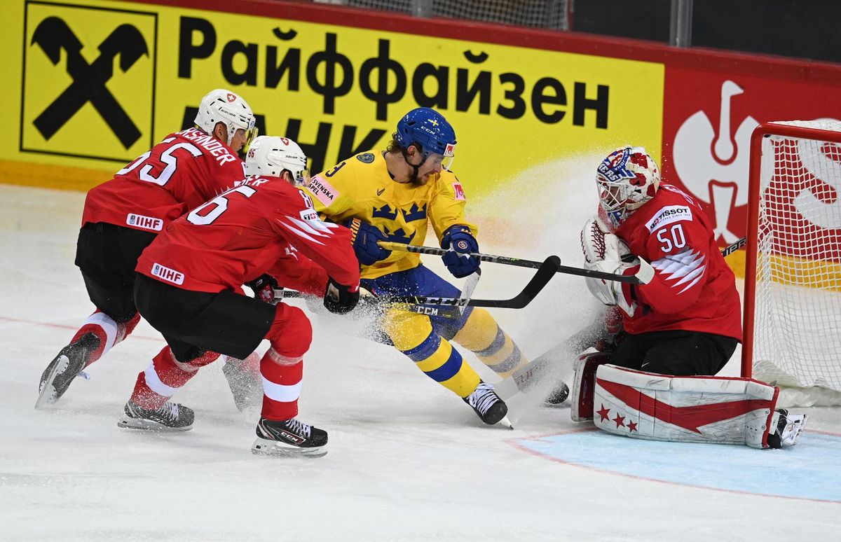 Switzerland's forward Tristan Scherwey (C) celebrates scoring his team's third goal with his team mates during the IIHF Men's Ice Hockey World Championships preliminary round group A match between Czech Republic and Switzerland, at the Olympic Sports Center in Riga, Latvia, on May 22, 2021. (Photo by Gints IVUSKANS / AFP)