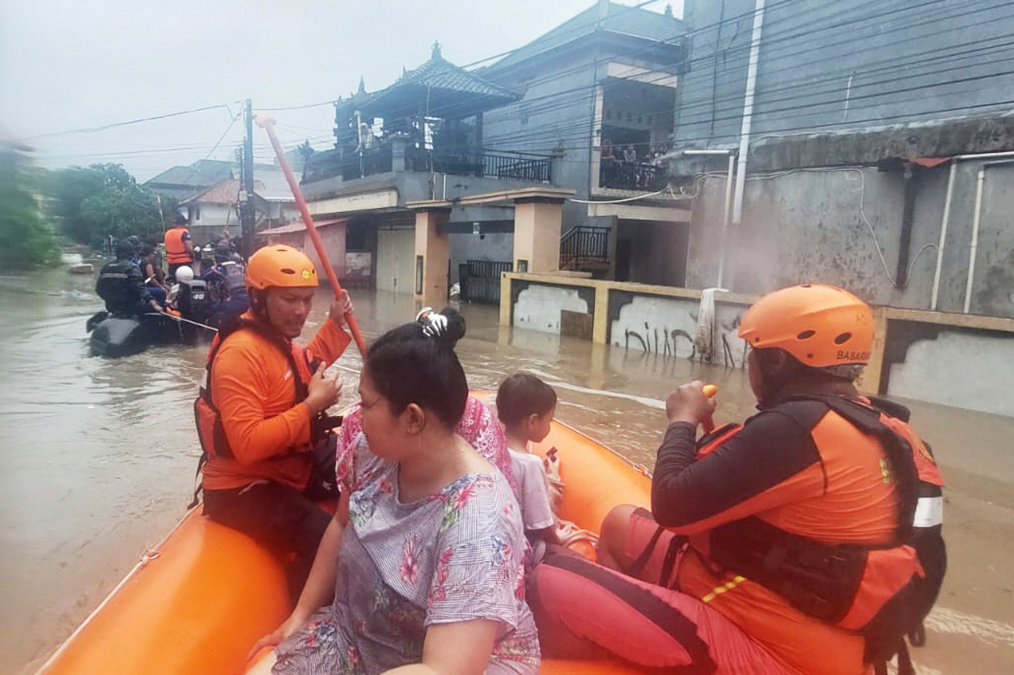 Rettungskräfte in einem Schlauchboot evakuieren Bewohner aus ihrem überfluteten Haus in Denpasar, Bali, Indonesien.