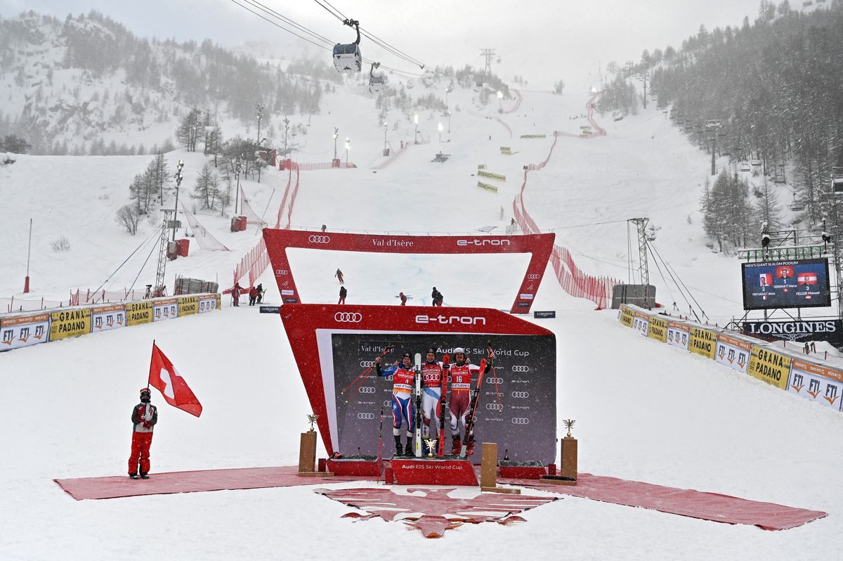 Second-placed France's Alexis Pinturault (L), First-placed Switzerland's Marco Odermatt (C) and Third-placed Austria's Manuel Feller celebrate on the podium after the Men's Giant Slalom event during the FIS Alpine ski World Cup in Val-d'Isere, on December 11, 2021. (Photo by Jeff PACHOUD / AFP)