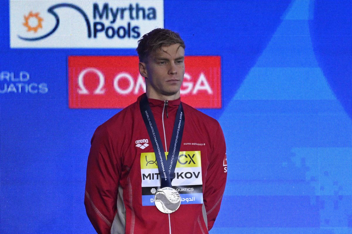Silver medallist Switzerland's Roman Mityukov poses on the podium of the men's 200m backstroke swimming event during the 2024 World Aquatics Championships at Aspire Dome in Doha on February 16, 2024. (Photo by Oli SCARFF / AFP)