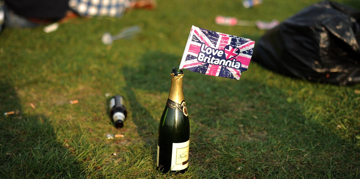 A British Union Jack flag rests in a bottle of champagne as royal supporters gather on Clapham Common, in south west London, to celebrate the royal wedding of Britain's Prince William and Kate, Duchess of Cambridge, on April 29, 2011. AFP PHOTO/BEN STANSALL (Photo by BEN STANSALL / AFP)