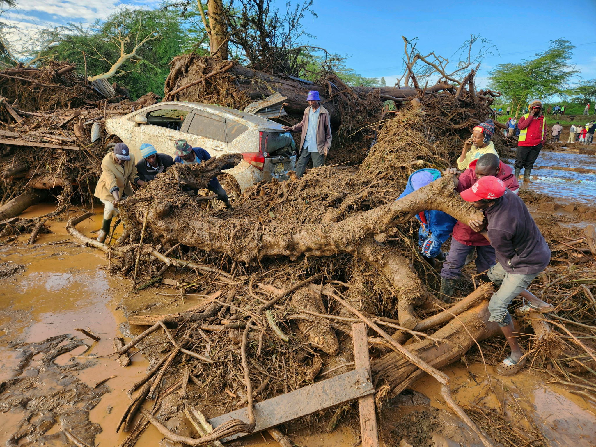 People try to clear the area after a dam burst, in Kamuchiri Village Mai Mahiu, Nakuru County, Kenya, Monday, April 29, 2024. Police in Kenya say at least 40 people have died after a dam collapsed in the country's west.  (AP Photo)