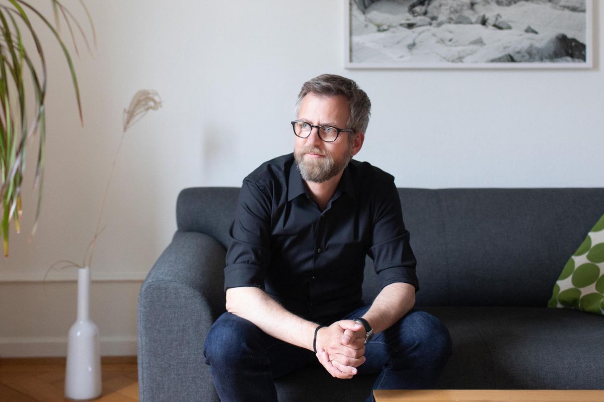 LAUSANNE ,  le 21 mai 2021. Pascal Gygax pose chez lui devant une photo de Matthieu Gafsou, qui évoque sa passion pour la randonnée en montagne.