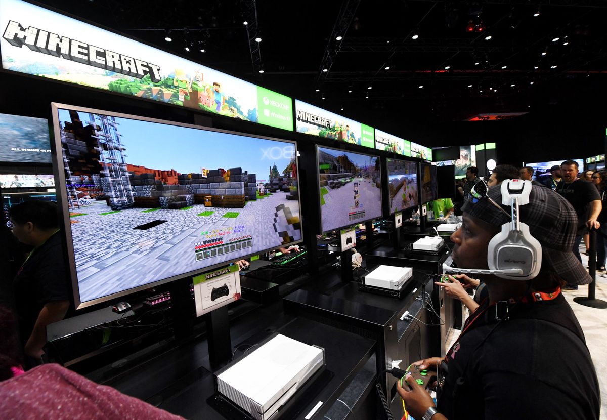 Gamers in the Microsoft Xbox exhibit play the "Minecraft" game at the Los Angeles Convention center on day one of E3 2017, the three day Electronic Entertainment Expo, one of the biggest events in the gaming industry calendar, in Los Angeles, California on June 13, 2017. (Photo by Mark RALSTON / AFP)