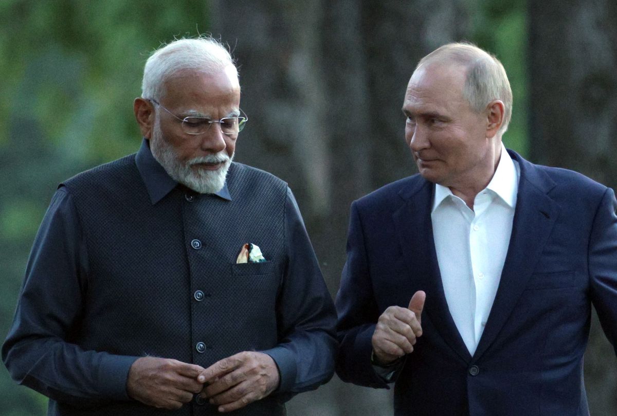 In this pool photograph distributed by the Russian state agency Sputnik, Russia's President Vladimir Putin and Indian Prime Minister Narendra Modi take a walk during an informal meeting at the Novo-Ogaryovo state residence, outside Moscow, on July 8, 2024. (Photo by Gavriil GRIGOROV / POOL / AFP)