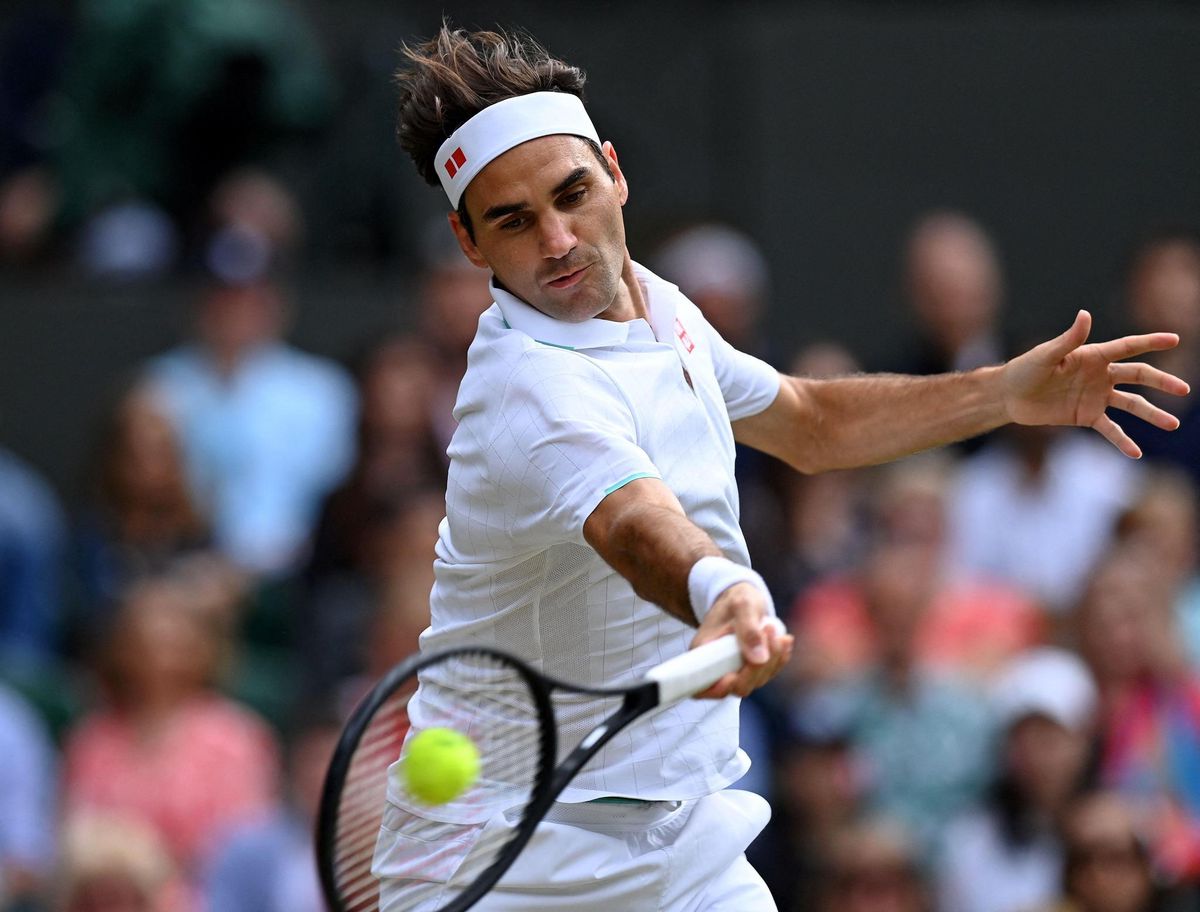 TOPSHOT - Switzerland's Roger Federer jumps to play a return against Italy's Lorenzo Sonego during their men's singles fourth round match on the seventh day of the 2021 Wimbledon Championships at The All England Tennis Club in Wimbledon, southwest London, on July 5, 2021. (Photo by Glyn KIRK / AFP) / RESTRICTED TO EDITORIAL USE