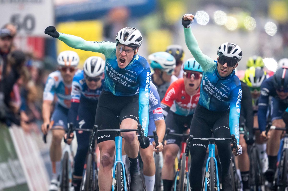 French cyclist Dorian Godon (L) of Decathlon AG2R La Mondiale Team crosses the finish line to win the first stage of the Tour of Romandy UCI cycling World tour 165,7 km from Chateau d'Oex to Fribourg, on April 24, 2024. (Photo by Fabrice COFFRINI / AFP)