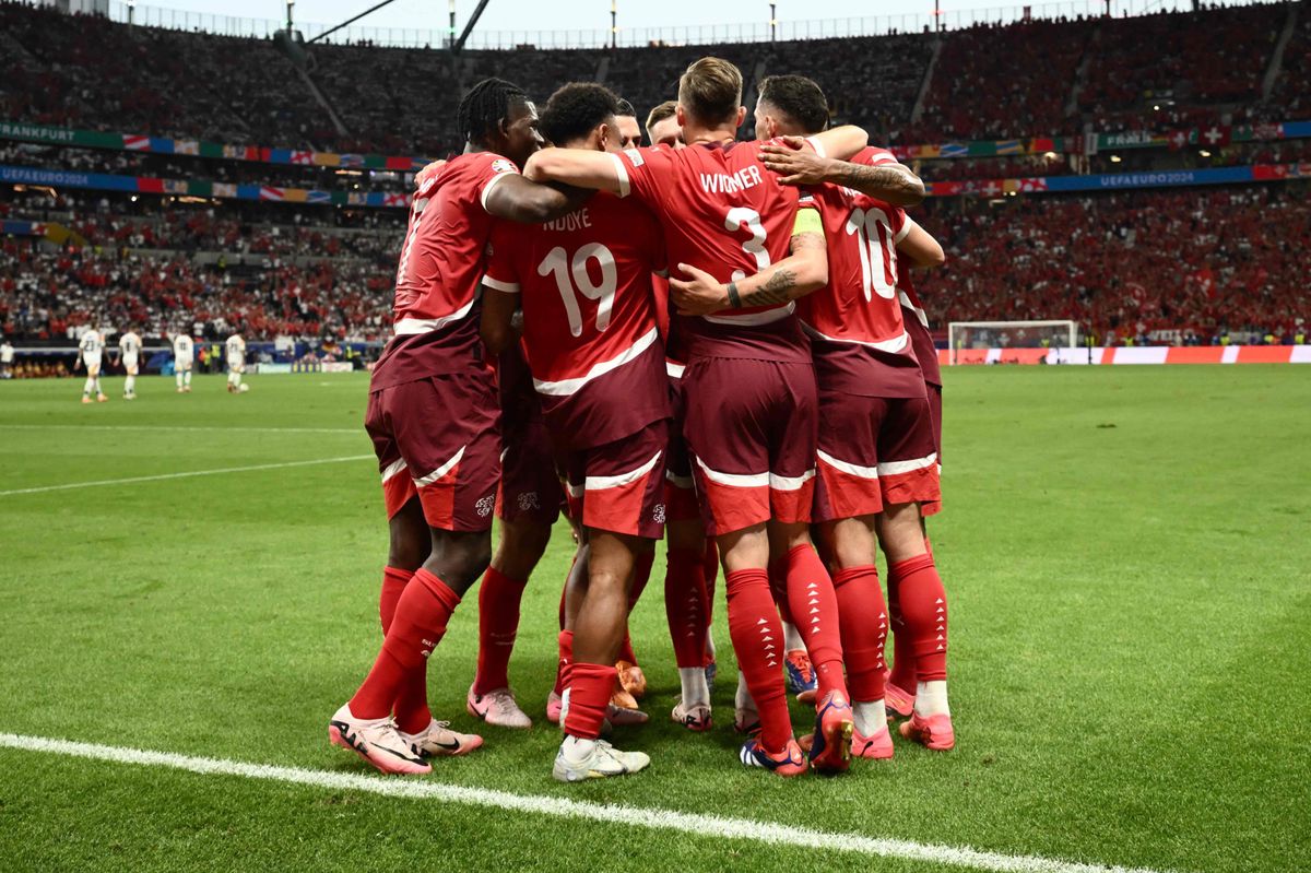 TOPSHOT - Switzerland's forward #19 Dan Ndoye celebrates scoring his team's first goal with his team mates during the UEFA Euro 2024 Group A football match between Switzerland and Germany at the Frankfurt Arena in Frankfurt am Main on June 23, 2024. (Photo by Angelos TZORTZINIS / AFP)