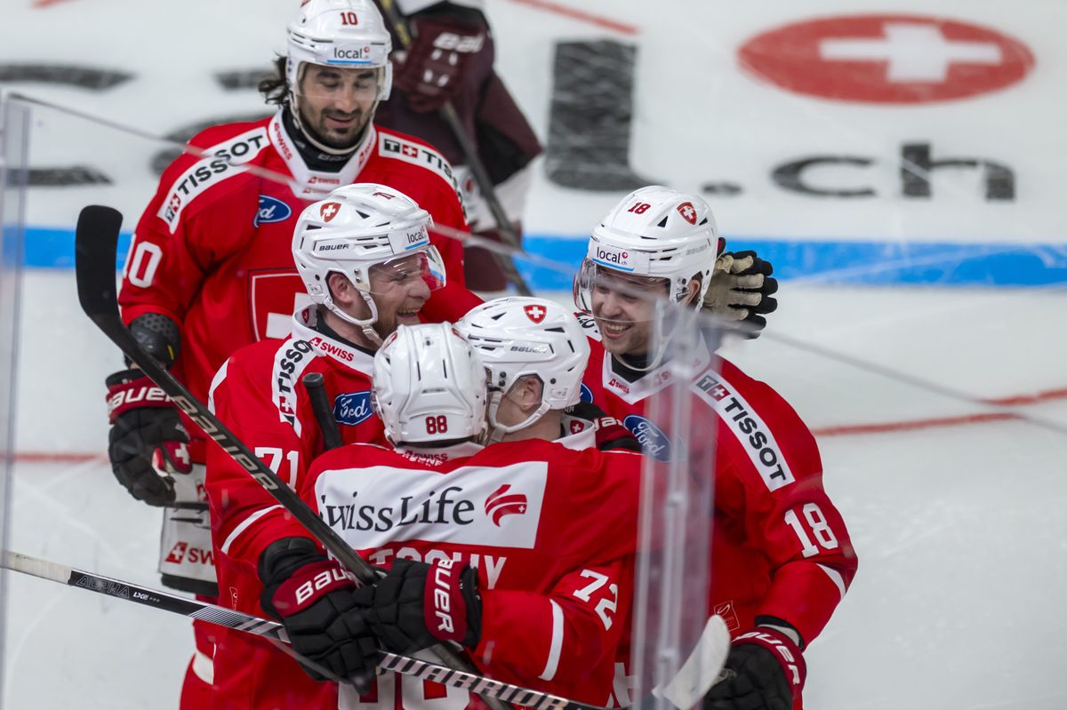 The Swiss players burst into joy after scoring the 2:0, during an ice hockey World Cup preparation match between Switzerland and Latvia at the Vaudoise Arena in Lausanne, Switzerland, Friday, April 26, 2024. (KEYSTONE/Martial Trezzini)