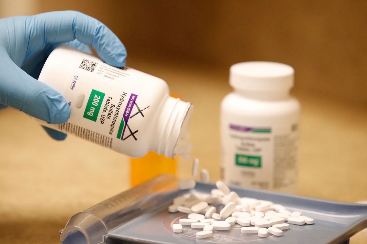 A pharmacy tech pours out pills of Hydroxychloroquine at Rock Canyon Pharmacy in Provo, Utah, on May 20, 2020. US President Donald Trump announced May 18 he has been taking hydroxychloroquine for almost two weeks as a preventative measure against COVID-19. (Photo by GEORGE FREY / AFP)