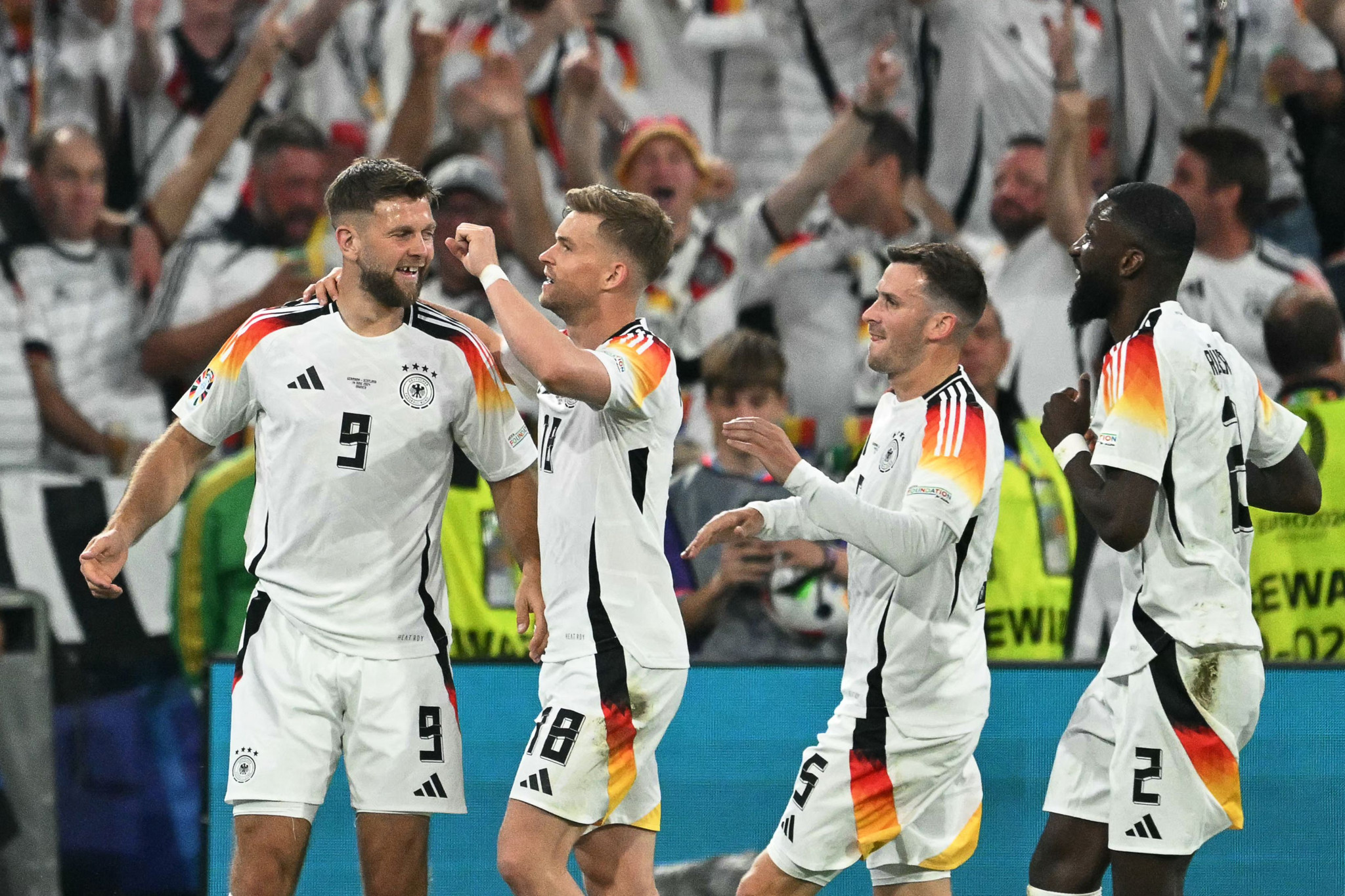 Germany's forward #09 Niclas Fuellkrug (L) celebrates scoring his team's fourth goal during the UEFA Euro 2024 Group A football match between Germany and Scotland at the Munich Football Arena in Munich on June 14, 2024. (Photo by MIGUEL MEDINA / AFP)