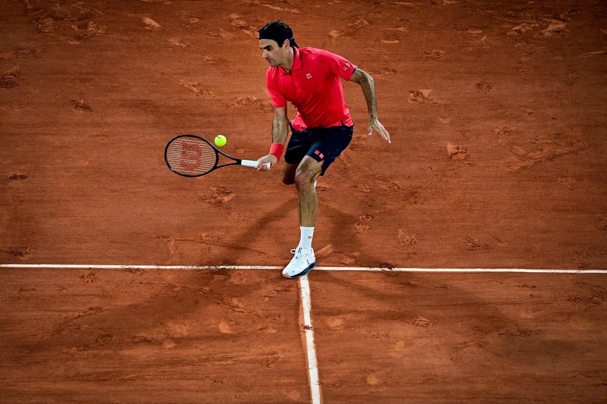 TOPSHOT - Switzerland's Roger Federer serves the ball to Croatia's Marin Cilic during their men's singles second round tennis match on Day 5 of The Roland Garros 2021 French Open tennis tournament in Paris on June 3, 2021. (Photo by Anne-Christine POUJOULAT / AFP)