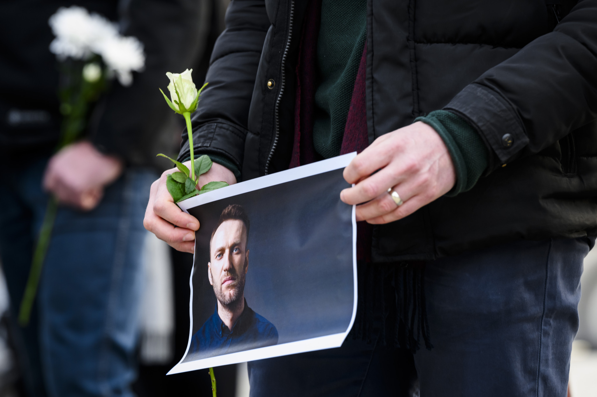 Protestor holds placard with a picture of Alexei Navalny after the announcement of the death of Russian opposition leader Alexei Navalny, on the place des Nations in front of the European headquarters of the United Nations, in Geneva, Switzerland, Friday, February 16, 2024. Russian opposition leader and outspoken Kremlin critic Alexey Navalny has died aged 47 in a penal colony, the Federal Penitentiary Service of the Yamalo-Nenets Autonomous District. (KEYSTONE/Martial Trezzini)