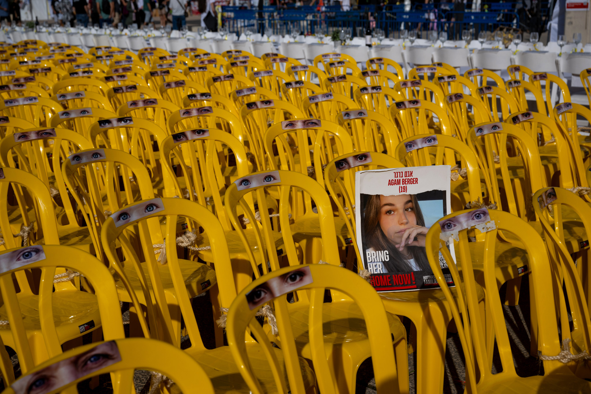 TEL AVIV, ISRAEL - NOVEMBER 24: A photo of Agam Berger, 19, on a poster is displayed among empty chairs with eyes on them representing the hostages, outside The Museum of Modern Art known as the 'The Hostages and Missing Square' on November 24, 2023 in Tel Aviv, Israel. A four-day ceasefire began between Israel and Hamas began this morning, although Israeli forces remain in Gaza. A total of 50 hostages currently held by Hamas are to be released during the temporary truce, the first such pause in fighting since Oct. 7, when Hamas launched its surprise attack and Israeli responded with a vast military offensive to destroy the militant group that governs Gaza. Under the deal, 150 Palestinian prisoners are also to be released from Israel, and more humanitarian aid will be admitted at the Gaza-Egypt border crossing. (Photo by Alexi J. Rosenfeld/Getty Images) *BESTPIX*