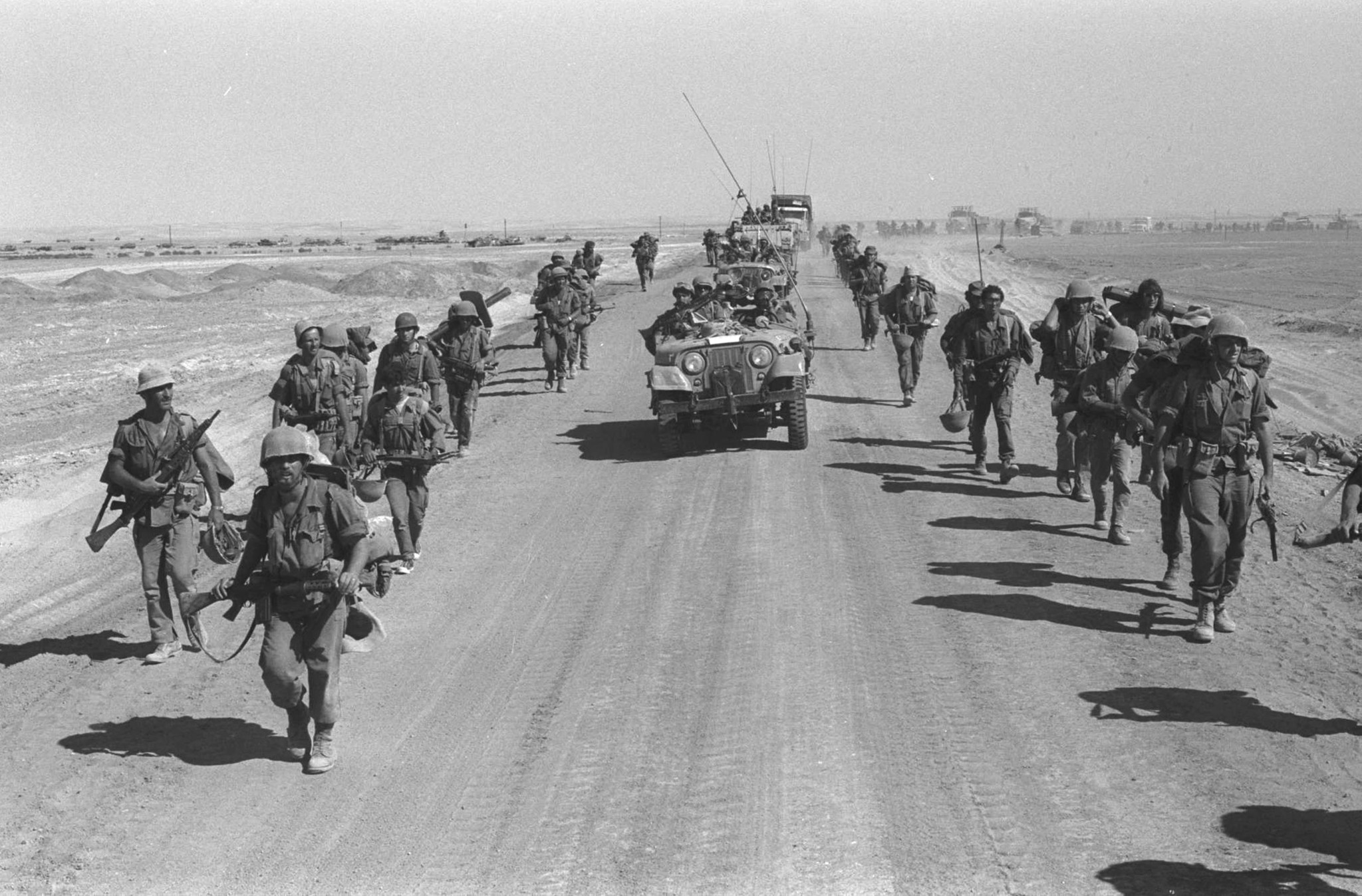 SUEZ-CAIRO ROAD, EGYPT -OCTOBER 25: (FILE PHOTO) Israeli  paratroopers march October 25, 1973 along the Suez-Cairo road on the western bank of the Suez Canal during the Yom Kippur War. Current Israeli Prime Minister Ariel Sharon, then a general in the Israeli army, refused to rule out another surprise attack similar to the one launched by the Arab armies when they struck against Israeli troops in the Sinai Desert and Golan Heights on the holiest day of the Jewish calendar on October 6, 1973. (Photo by Ilan Ron/GPO/Getty Images)