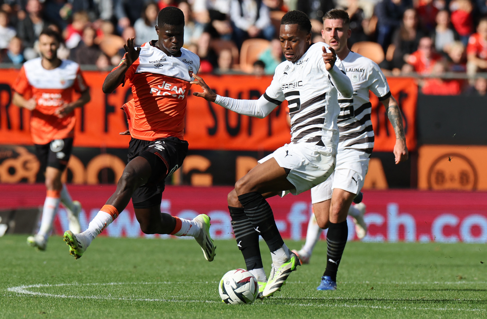 Lorient's forward #33 Bassirou Ndiaye (L) fights for the ball with Rennes' French defender #16 Jeanuel Belocian during the French L1 football match between FC Lorient and Stade Rennais FC at the Moustoir stadium in Lorient, western France, on October 22, 2023. (Photo by Fred TANNEAU / AFP)