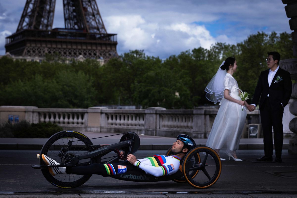 City of love, city of sports: Para-cyclist Florian Joanny rides over the Pont de Bir-Hakeim and past the Eiffel Tower.