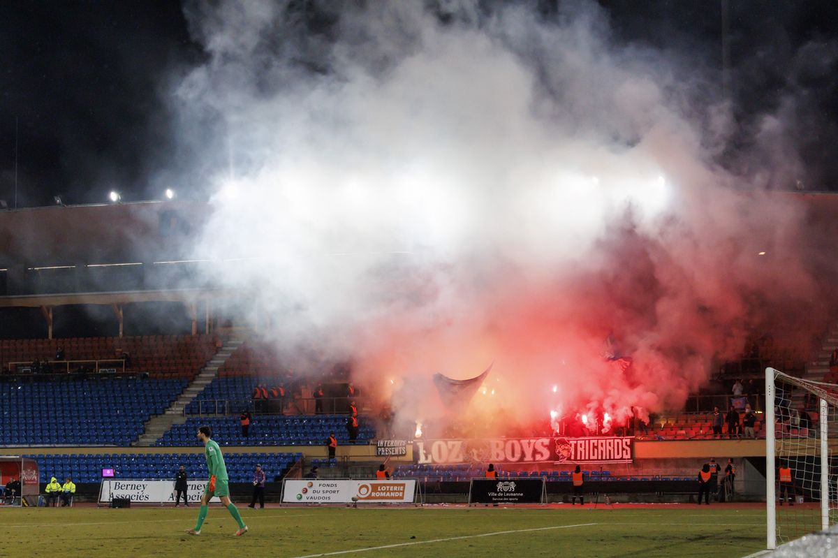 Lausanne ultra supporters light smoke flares, during the Super League soccer match of Swiss Championship between FC Stade-Lausanne-Ouchy and FC Lausanne-sport, at the Stade Olympique de la Pontaise stadium, in Lausanne, Switzerland, Saturday, February 10, 2024. (KEYSTONE/Salvatore Di Nolfi)