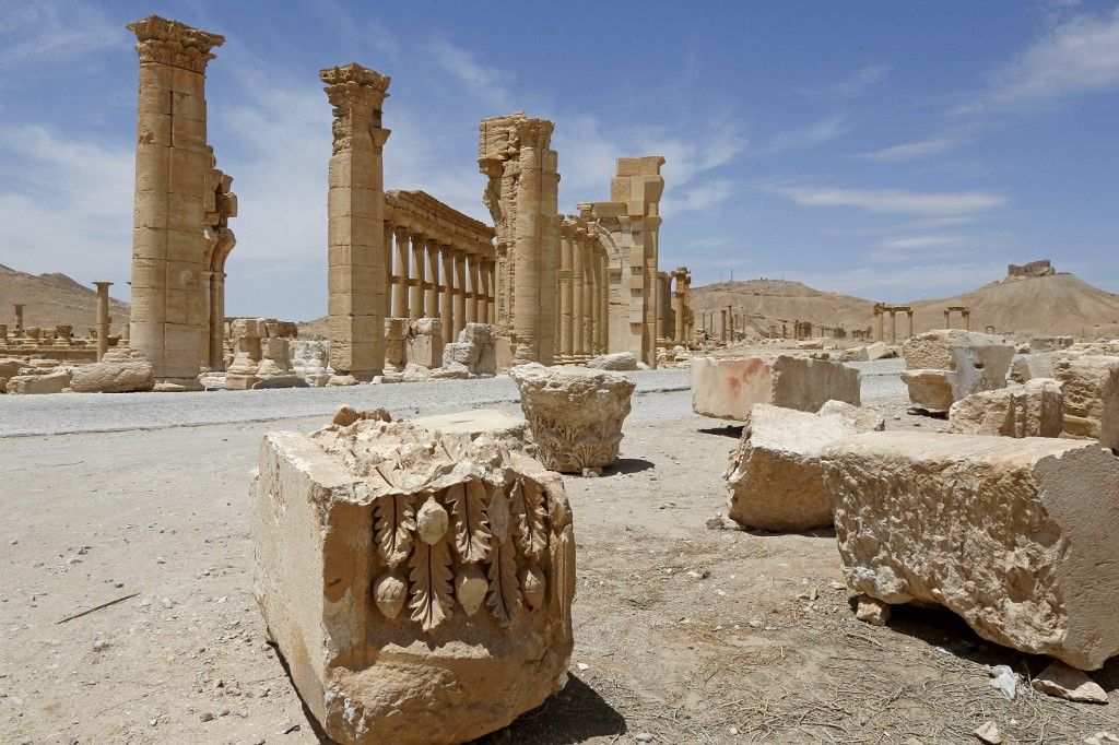 This picture taken on May 9, 2022 shows a view of the remains of the Triumphal Arch of Septimius Severus built during the reign of the 3rd-century Roman emperor, and destroyed by Islamic State (IS) group militants in 2015, in the ruins of Syria's Roman-era ancient city of Palmyra.  (Photo by LOUAI BESHARA / AFP)