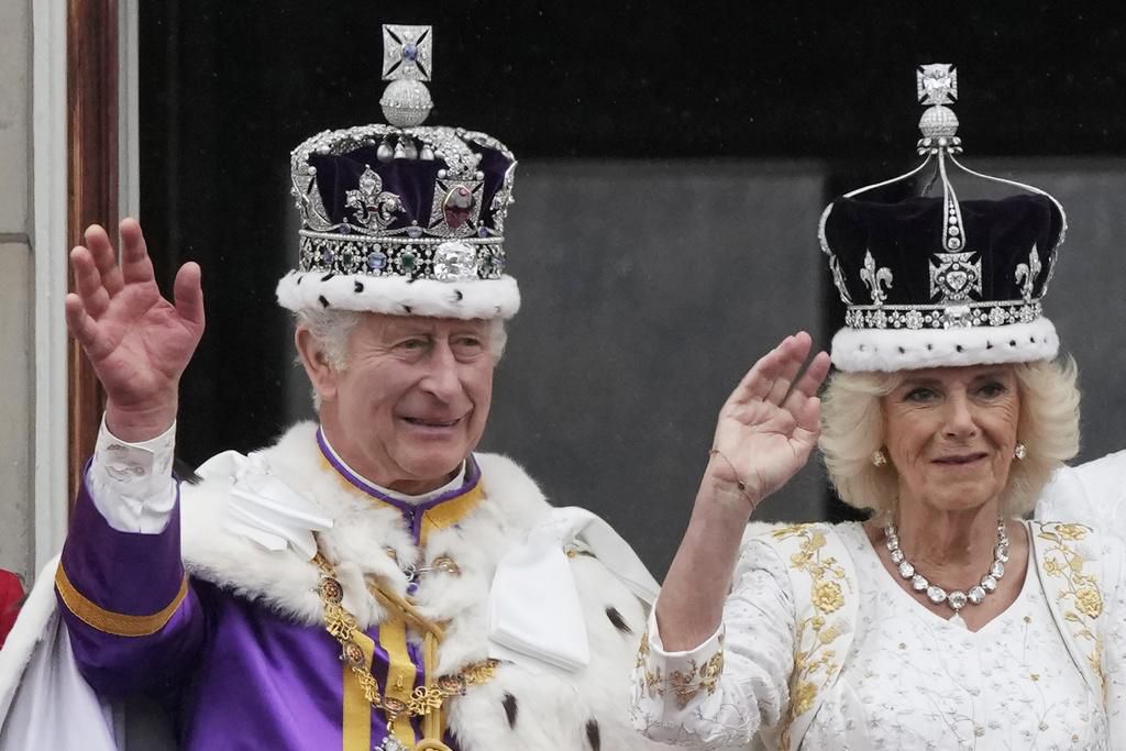 Britain's King Charles III greets well-wishers outside Buckingham Palace, in London, Friday, May 5, 2023 a day before his coronation takes place at Westminster Abbey. (Toby Melville, Pool via AP)