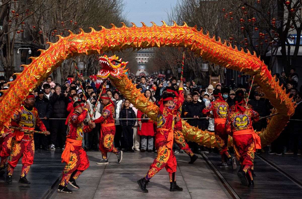 BEIJING, CHINA - FEBRUARY 11: Chinese performers take part in a dragon dance in the street for the Chinese Lunar New Year and Spring Festival in a historic neighbourhood on February 11, 2024 in Beijing, China. China ushered in the Year of the Dragon on the first day of the Lunar New Year and Spring Festival on February 10th. (Photo by Kevin Frayer/Getty Images)